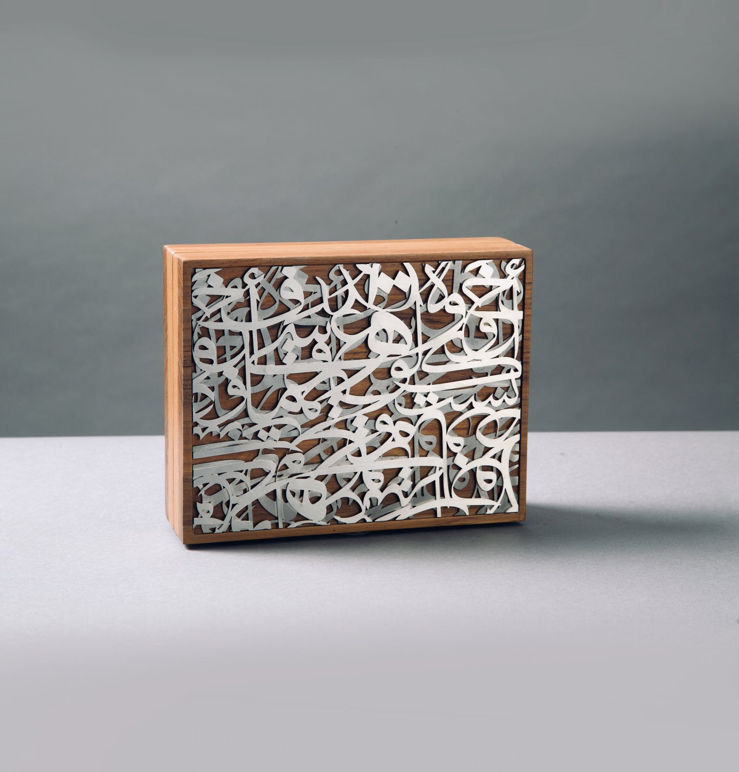 Overlapping Caligraphy steel x wooden clutch